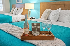 This spacious bedroom boasts 2 plush queen-sized beds and mounted Smart TV. The ultimate relaxation destination after a long beach day. Get your rest and recharge right here. The room also has plenty of storage space for those longer stays as well.