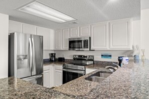 This fully stocked kitchen gives you all the comforts of home.  Serve a full meal in this kitchen with double undermounted sink, refrigerator, freezer, stove, oven, microwave, coffee maker (drip and Keurig), toaster, and plenty of storage options.