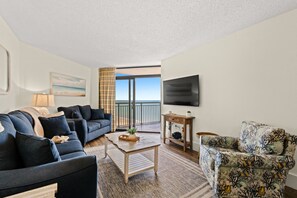 This living room gives you a million dollar view of the Myrtle Beach shoreline and beach.  Relax on a full sofa, love seat, and single swivel chair.  Stream your favorite shows on this Smart TV.  Gives you Direct balcony access from the living room.