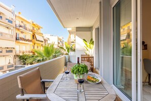 Relax in style on the roomy balcony, complete with comfy outdoor furniture.