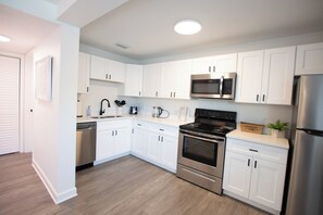 Full kitchen with modern stainless appliances. 