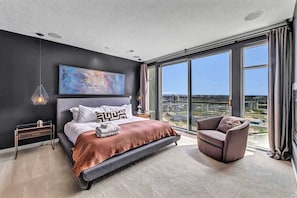 Modern comfort with a view, snuggle up by the fire, soak in skyline views, and unwind in a sleek, sun-drenched bedroom retreat.