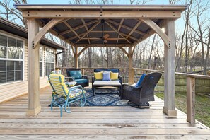 Peaceful, fully fenced in back yard with seating, a grill, and a fire pit!