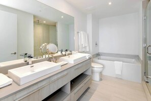 Our stunning Master bathroom, where you can decide whether to take a good shower or go right into the bathtub for a relaxing bubble bath! It includes towels, a hairdryer, and a starter kit.