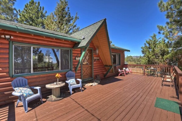 "Relax in rustic comfort on our spacious deck, where cozy Adirondack chairs invite you to soak in the serene forest views.