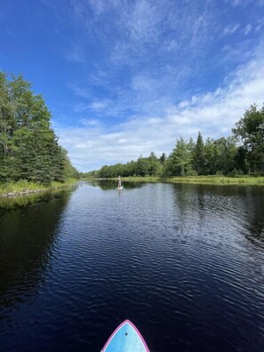 Paddling on the creek, accessed by our trails