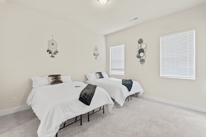 Spacious bedroom that offers two full-size beds.