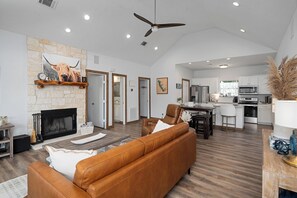 Living room #1 - with couch, chair, fireplace and TV.