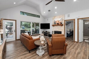 Living room #1 - with couch, chair, fireplace and TV.