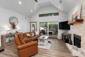 Living room #1 - with couch, chair, fireplace and TV.
