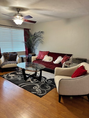 Living room with glass tabletops and seating for 5