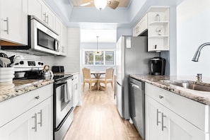 Enjoy ample cabinetry and generous counter space, making meal prep easy and organized in this functional kitchen