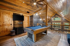 Game area upstairs which includes a pool table and arcade