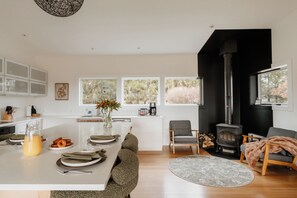 Modern kitchen with adjacent wood stove. 