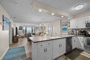 Open concept kitchen, dining & living space