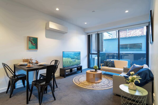 Living room with large smart TV and plenty of seating area