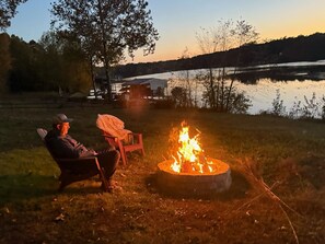 Nestled in the backyard with stunning lake views, our fire pit is the ultimate gathering spot. Firewood is provided, so you can sit back, roast marshmallows, and soak in the peaceful ambiance of the water and your natural surroundings.