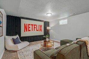 Lower level lounge with huge projector screen and foosball- perfect for movie nights!