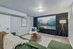Lower level lounge with huge projector screen and foosball- perfect for movie nights!