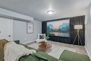 Lower level lounge with huge projector screen and foosball- perfect for movie nights!