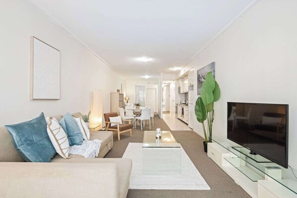 A living area with a 3-seater sofa bed