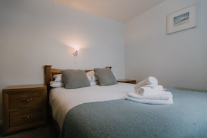The Carthouse master bedroom at Trevalgan Farm Holidays