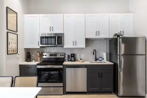As you open the kitchen, you discover an assortment of coffee pods, and sugar, ensuring you have everything you need for a perfect morning or afternoon pick-me-up.