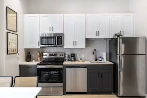 As you open the kitchen, you discover an assortment of coffee pods, and sugar, ensuring you have everything you need for a perfect morning or afternoon pick-me-up.