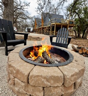 Wood burning fire pit shared between our treehouse units,  with wood provided. Firestarters and lighters in the outdoor box.