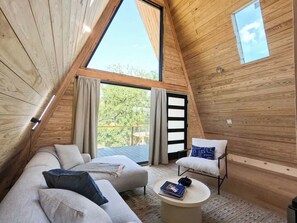 Cozy sitting area with view out floor to ceiling window. 