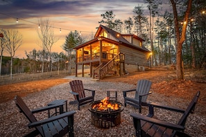 The glow of the fire and cabin lights create a welcoming scene after a day of mountain adventures. Unwind with your crew and soak in the mountain escape.