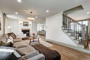 Living room with fireplace. Stairway leading to 2nd floor.