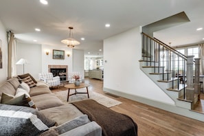 Living room with fireplace. Stairway leading to 2nd floor.