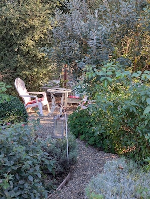 Relax and unwind in the serene backyard garden, surrounded by vibrant flowers and tranquil countryside views.