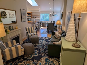Step inside to a bright and inviting open-concept living space, where the cozy seating area flows seamlessly into the dining and kitchen areas—perfect for gathering and making memories.