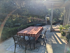 Dine al fresco on the back patio, surrounded by lush gardens and the peaceful beauty of the countryside.