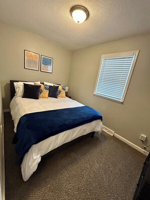 Second bedroom with storage dresser, QUEEN bed, closet.