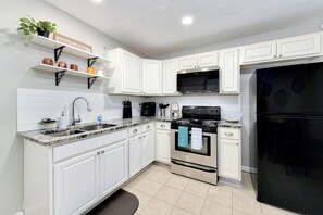 Spacious kitchen with dining table, and fully stocked to cook at home.