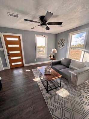 2nd level living space with 60" ROKU Smart TV and access to 2nd level balcony with downtown views