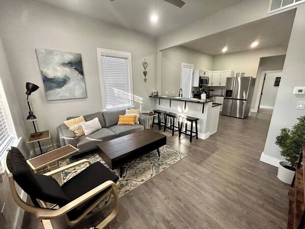 Spacious open concept living room/kitchen space, with breakfast bar.