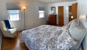 Primary bedroom with queen bed and three closets