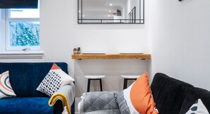 Cozy Dining Space for Two | Enjoy meals in this inviting living room area, perfect for a relaxed and comfortable stay. Whether it's a quick breakfast or a homemade dinner, you'll feel right at home