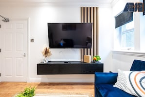 Relax in style! Our cozy living room features two comfy sofas and a 50” TV—perfect for movie nights or unwinding after a long day.
