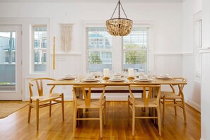 A luxurious dining space with wishbone chairs and a large wooden table