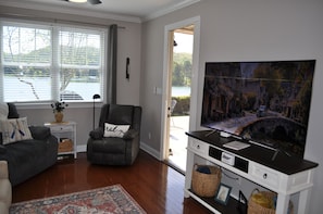 Sliding full screen door to enjoy the fresh air. Large curved screen TV w/ Roku