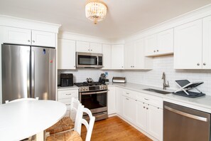 Modern kitchen featuring stainless steel appliances and everything you need for convenient at-home dining.