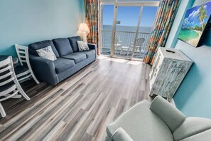 Updated living room with doors to oceanfront balcony. Come enjoy watching the waves crash.