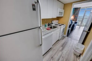 Walk thru kitchen provides the space to make meals in the condo.