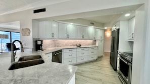 Fully-equipped kitchen; quartz countertops.