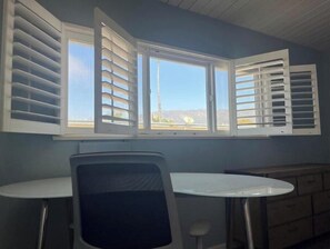 Office desk with monitor in located in the large bedroom